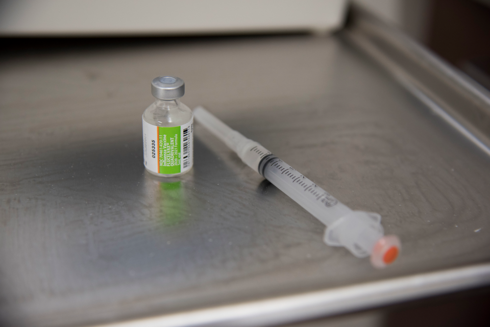 A medical needle and vial.