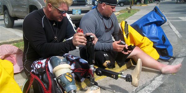 Kevin Pannell (left) works on Andrew Butterworth's broken prosthetic leg in Cruz Bay, St. John, U.S. Virgin Islands on October 21, 2007. The two former soldiers, who both lost legs serving in Operation Iraqi Freedom, were part of a small group of wounded veterans on a paddling trip to the island (OSD/DVIDS).