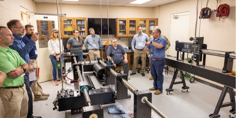Dr. Robert Moser, ERDC's Senior Scientific Technical Manager, discusses advanced materials and experimental testing capabilities with USACE District personnel. (ERDC)