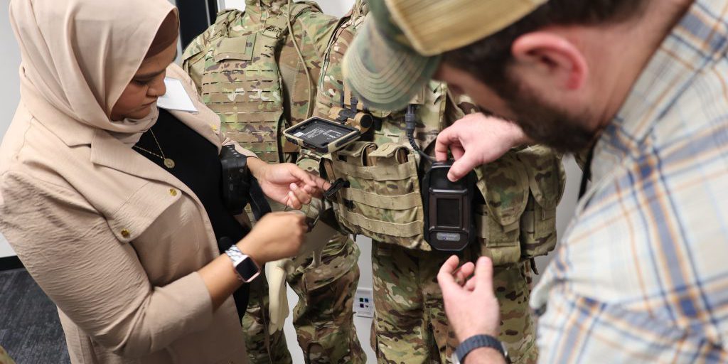 Staff fit a mannequin with a compact vapor chemical agent detector (CVCAD) prototype to test how a future Soldier may wear the CBRN sensor as part of their future kit (JPEO-CBRND)