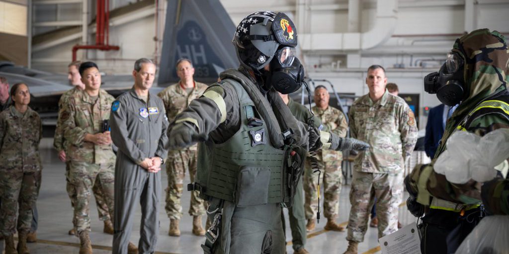 U.S. Air Force Capt. “Doom” Moss,  F-22A fighter pilot from the 19th Fighter Squadron, utilizes the aircrew ensemble respiratory protection system while processing through the aircrew contamination control area during the Next Generation Aircrew Protection step, launch, and recovery demonstration at Joint-Base Pearl Harbor-Hickam, Hawaii, May 11, 2023. The demonstration showcases the PACAF stop gap for the F-22 ACBRN LIMFAC utilizing the modified M-50 ground crew mask (U.S. Air National Guard photo by Master Sgt. Mysti Bicoy).