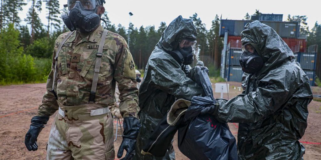 Finnish soldiers assigned to the Satakunta Jaeger Battalion decontaminates a U.S. soldier assigned to the 4th Squadron, 10th Cavalry Regiment, 3rd Armored Brigade Combat Team, 4th Infantry Division, during Finnish chemical, biological, radiological, and nuclear defense training at Säkylä, Finland, July 13, 2022. The 3rd Armored Brigade Combat Team, 4th Infantry Division, and the Pori Brigade of the Finnish army began summer training in Finland to strengthen relations and help build interoperability between the two nations (U.S. Army photo by Sgt. Andrew Greenwood).