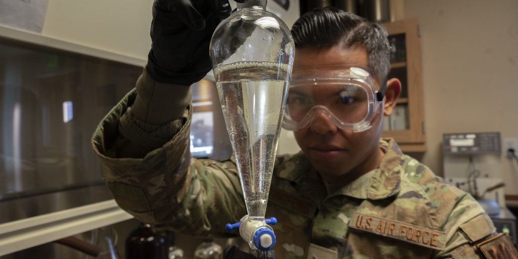 U.S. Air Force Staff Sgt. Austin Taitingfong, 49th Logistic Readiness Squadron Fuels Laboratory noncommissioned officer in charge, inspects a flask of jet fuel at Holloman Air Force Base, New Mexico on December 12, 2022. The 49th LRS fuels laboratory is the first line of defense for fuel quality control for all organizations on base (U.S. Air Force photo by Airman 1st Class Isaiah Pedrazzini).