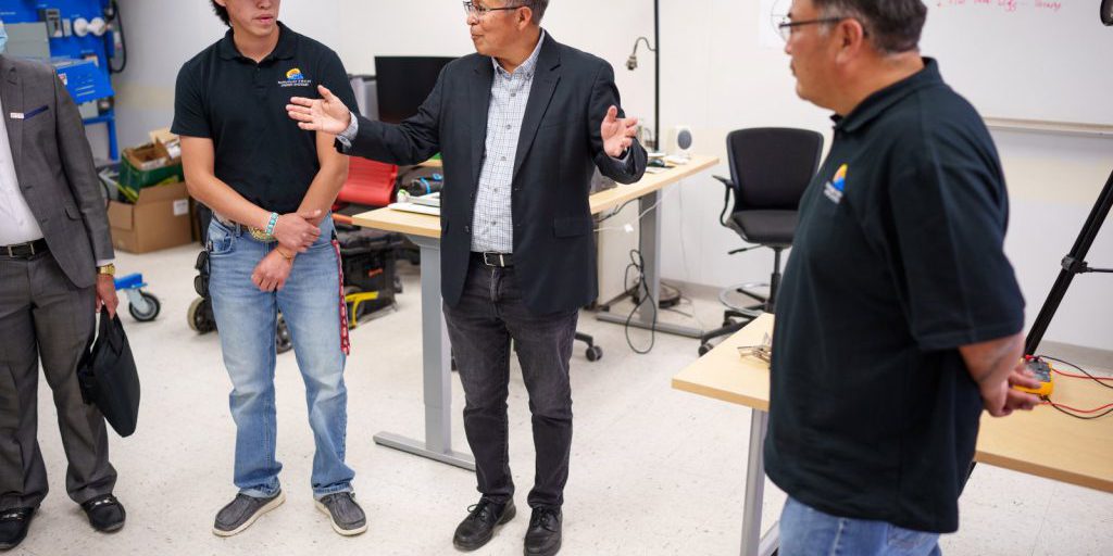 Sandia National Laboratories Senior Scientist Stan Atcitty. center, speaks during a visit to Navajo Technical University