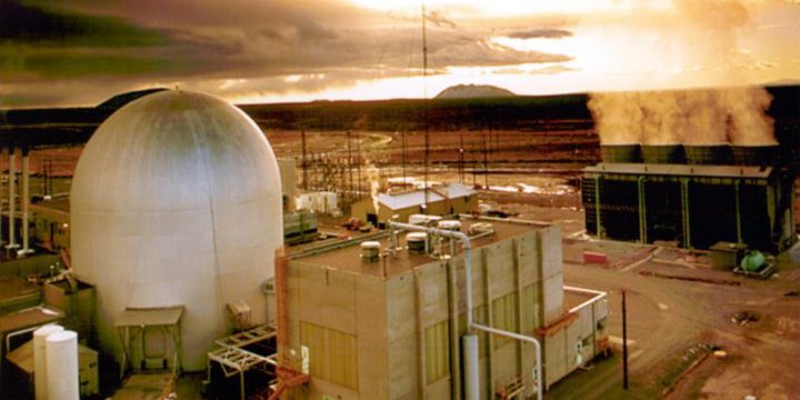 A picture of a nuclear testing facility, with a domed structure to the left and a building in the foreground.