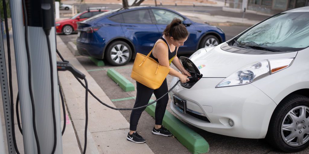 Kaedi Sanchez (cq) plugs in her car at City of Albuquerque’s charger on Amherst Drive before heading to work on Tuesday, Sept. 19, 2022 (photo by Craig Fritz).
