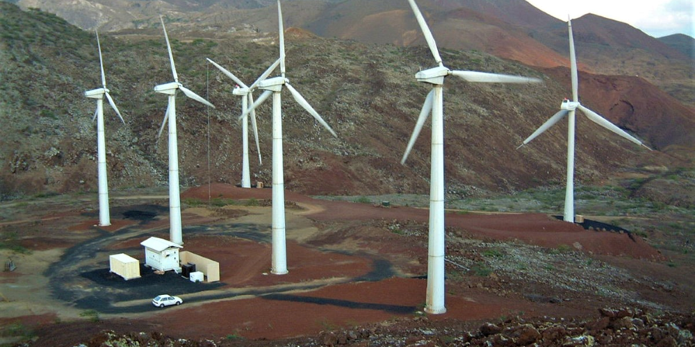 Wind farm with energy storage containers on site.