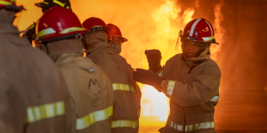 Servicemembers fight a fire under supervision