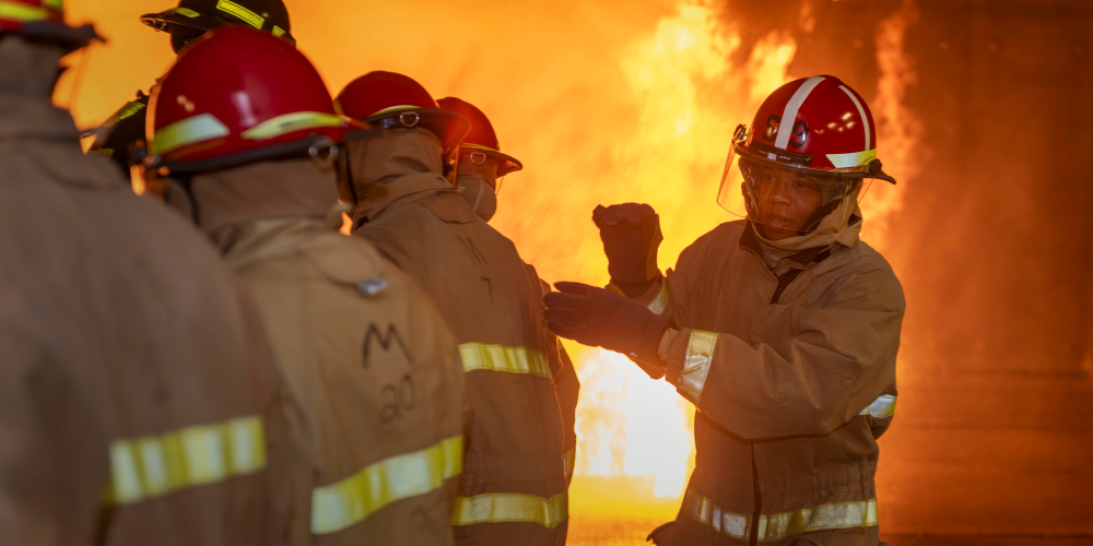 Servicemembers fight a fire under supervision