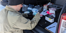 Army Captain conducting biological testing in the back of a SUV.