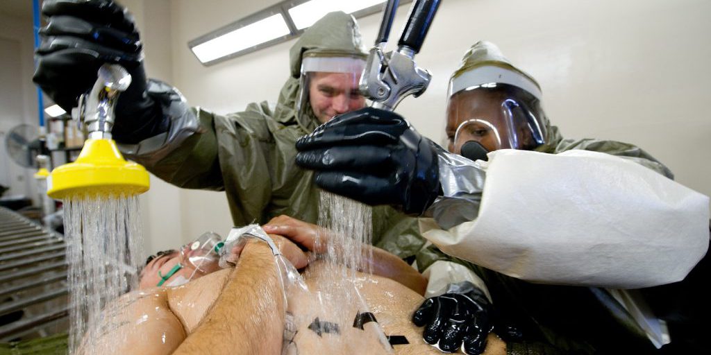 (Left to right) Senior Airman Clemente Fernandez, 374th Medical Support Squadron system technician, and Staff Sgt. Trishana Gwendo, 374th Aerospace Medicine Squadron nutritional medicine technician, practices decontamination procedures by spraying a simulated victim with water during a medical counter-chemical, biological, radiological and nuclear exercise scenario at Yokota Air Base, Japan, Nov. 4, 2011. The training experience is valuable to airmen because it tests their knowledge on how to identify and react to CBRN.
